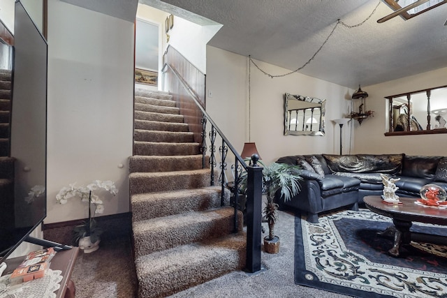 carpeted living room featuring a textured ceiling