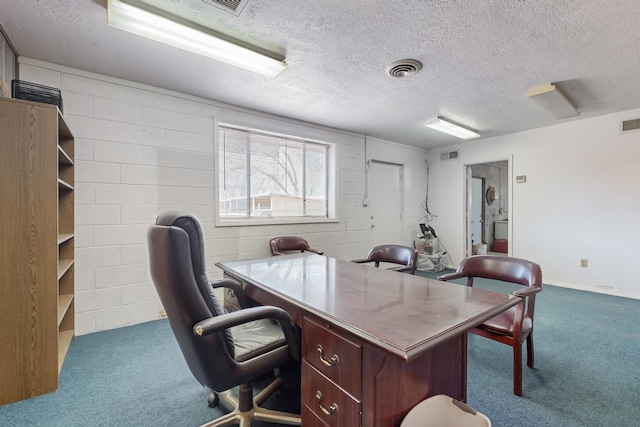 carpeted office space featuring a textured ceiling
