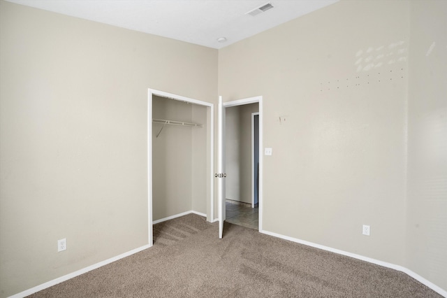 unfurnished bedroom with carpet and a closet