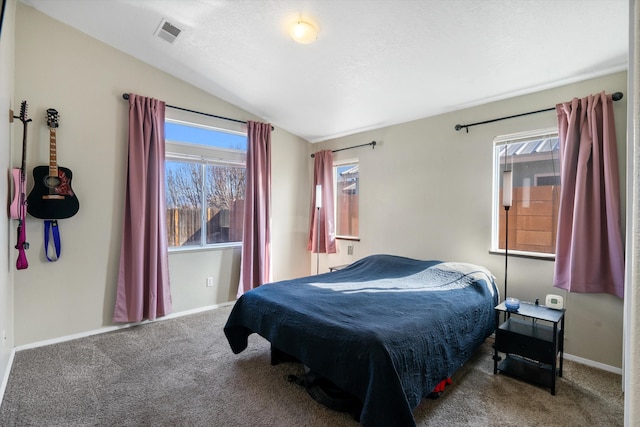 carpeted bedroom featuring vaulted ceiling and a textured ceiling