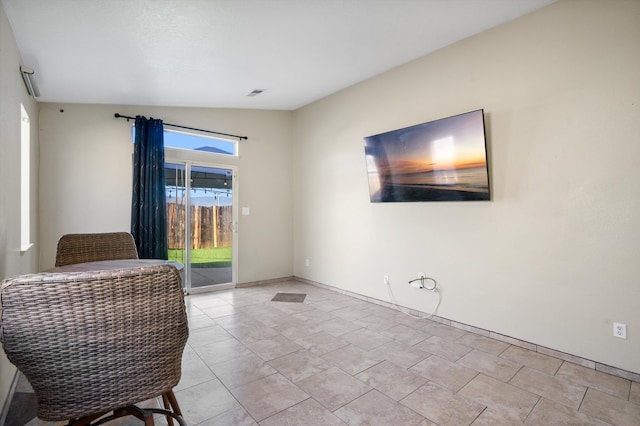 sitting room featuring lofted ceiling and light tile patterned floors