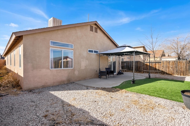 back of property featuring a patio, central AC unit, and a gazebo