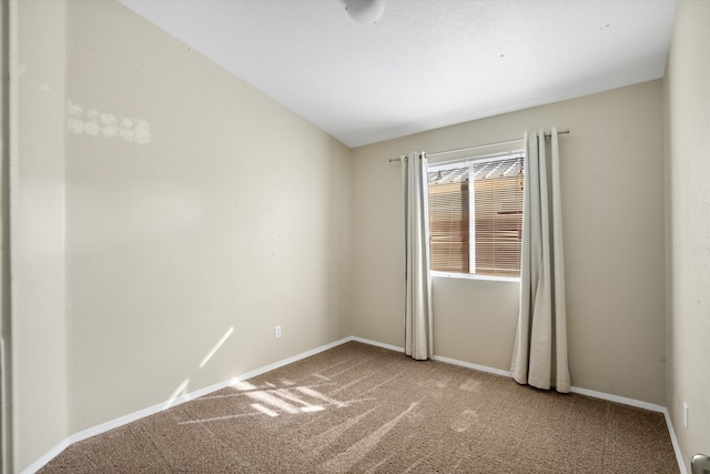 carpeted spare room with lofted ceiling