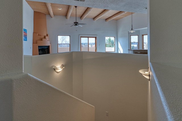 hallway with wood ceiling, visible vents, and beamed ceiling