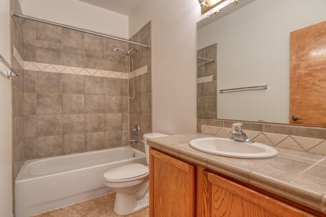 full bathroom featuring toilet, tile patterned floors, vanity, and bathing tub / shower combination