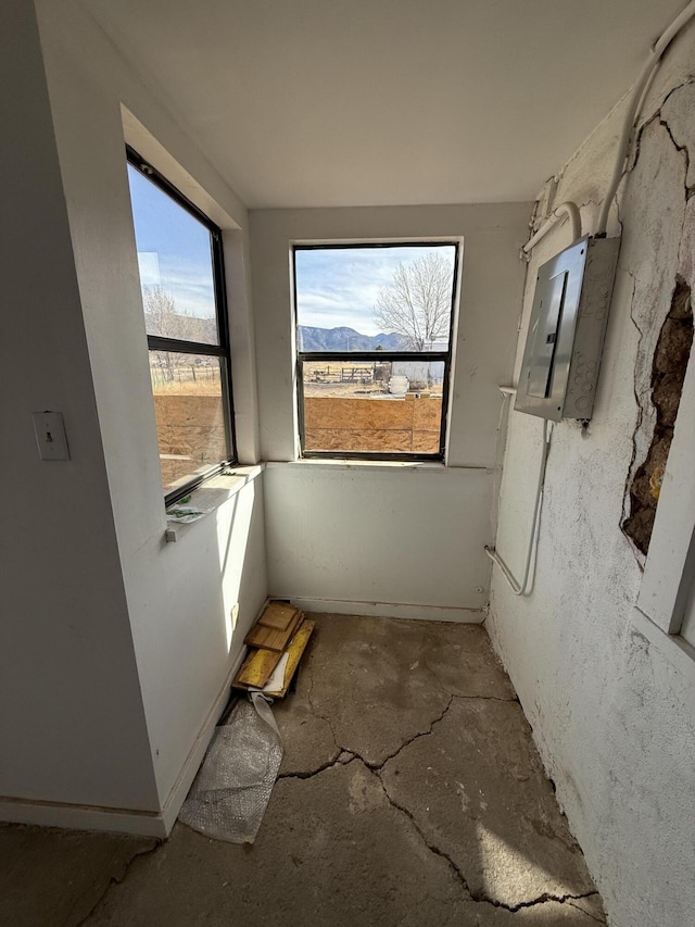 bathroom featuring a mountain view, electric panel, and concrete floors