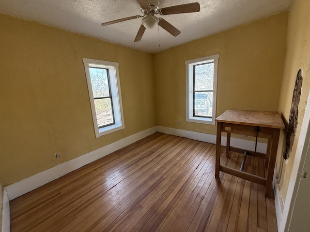 spare room featuring ceiling fan and wood-type flooring