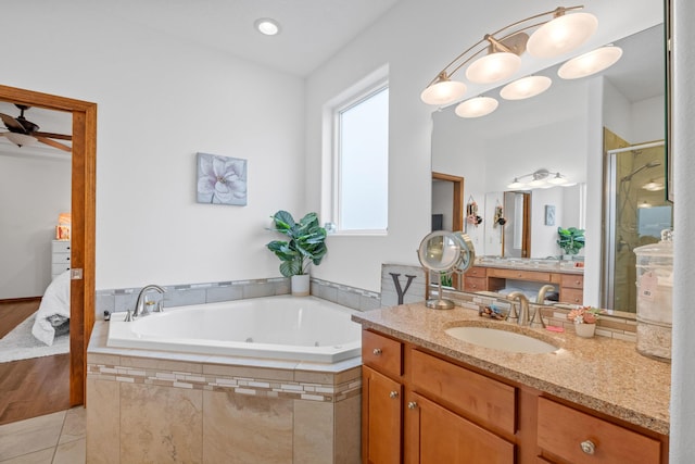 bathroom featuring tile patterned flooring, vanity, shower with separate bathtub, and ceiling fan