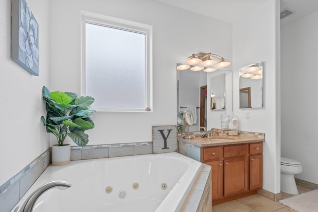 bathroom with a relaxing tiled tub, vanity, toilet, and a wealth of natural light