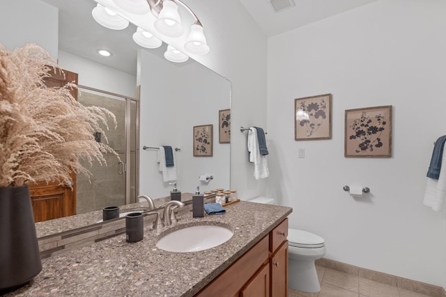 bathroom featuring tile patterned floors, toilet, a shower with door, and vanity