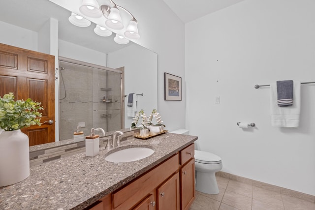 bathroom with toilet, vanity, tile patterned floors, and walk in shower