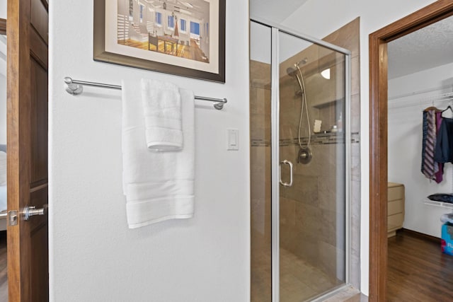 bathroom featuring an enclosed shower and hardwood / wood-style floors