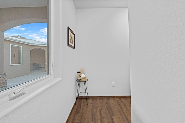 corridor with dark wood-type flooring