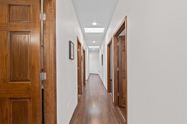 corridor with hardwood / wood-style flooring