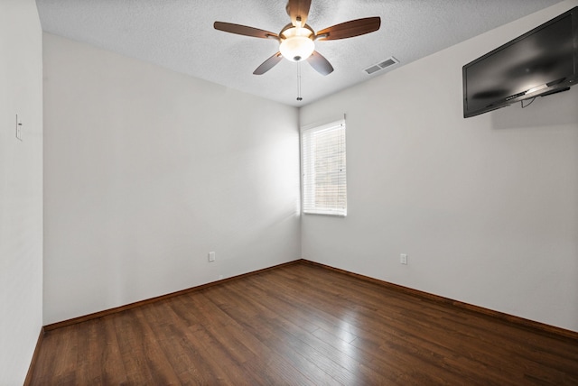 empty room featuring ceiling fan, wood-type flooring, and a textured ceiling