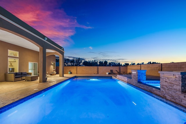 pool at dusk with a patio