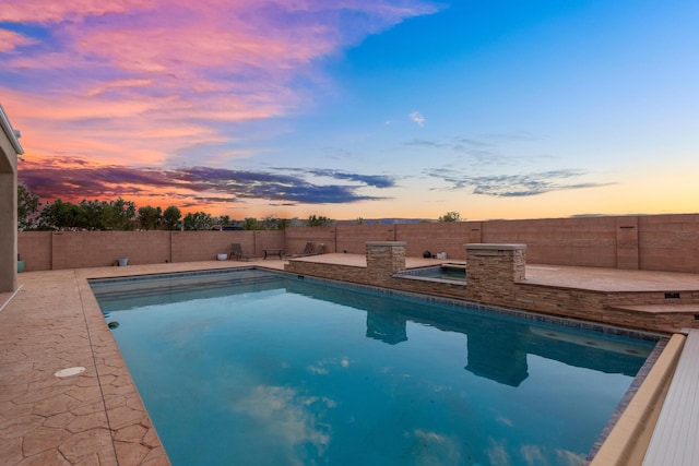 view of pool at dusk