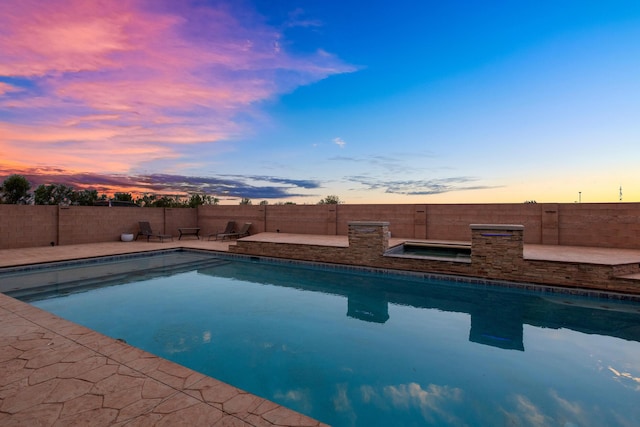 view of pool at dusk