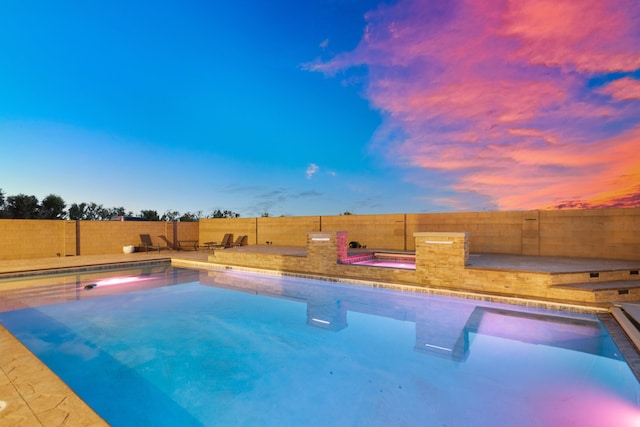 view of pool at dusk