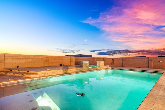 view of pool at dusk