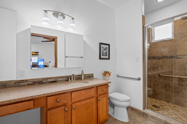 bathroom with vanity, tile patterned floors, toilet, and walk in shower