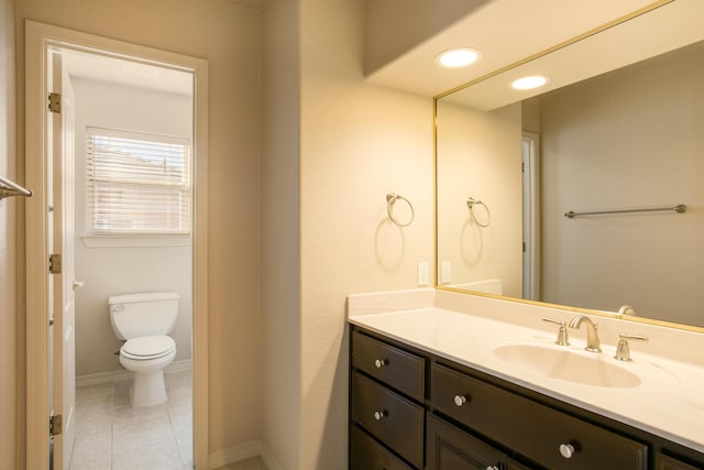 bathroom featuring vanity, tile patterned flooring, and toilet