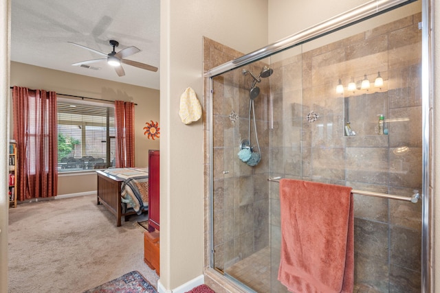 bathroom featuring ceiling fan and a shower with door