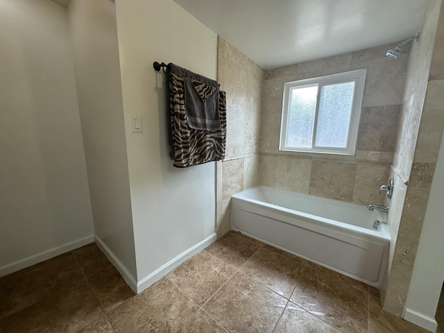 bathroom featuring  shower combination, tile patterned floors, and baseboards