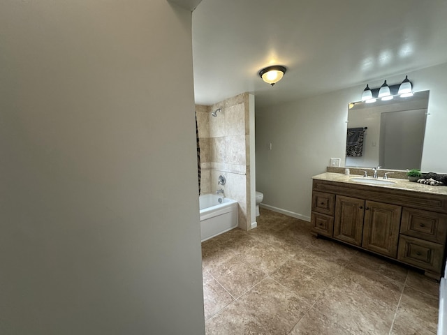 bathroom featuring toilet, washtub / shower combination, baseboards, and vanity