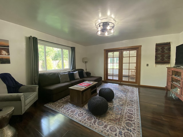 living area with baseboards and dark wood finished floors