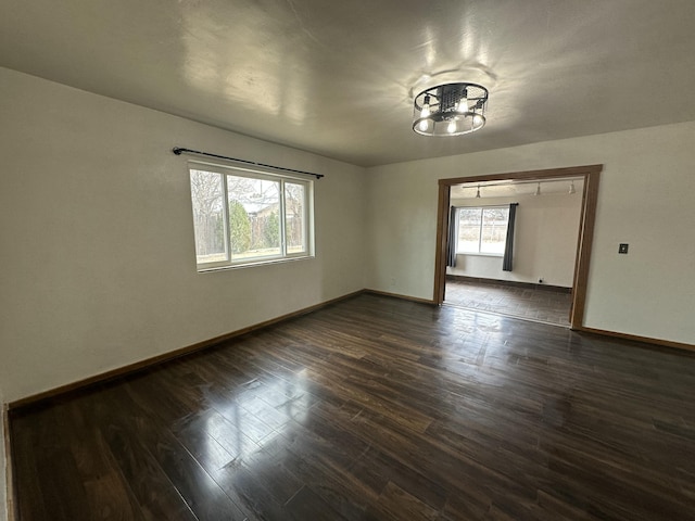 unfurnished room featuring dark wood finished floors and baseboards