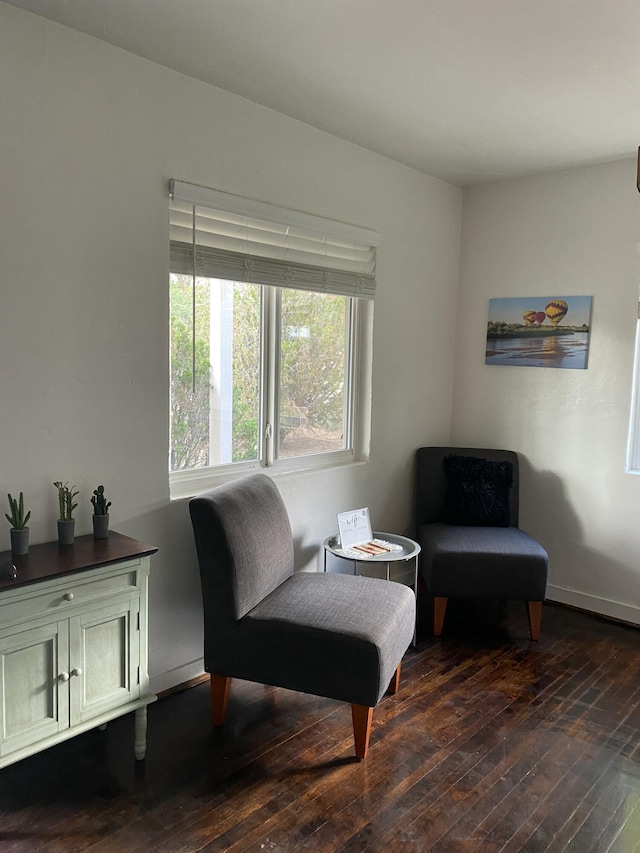 living area with dark wood finished floors and baseboards