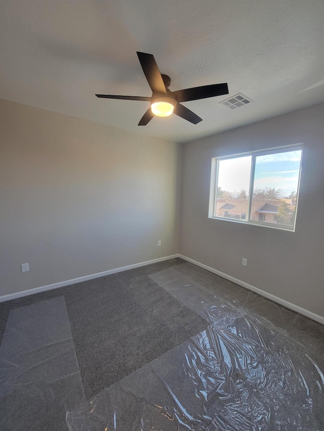 unfurnished room featuring a ceiling fan, baseboards, and visible vents