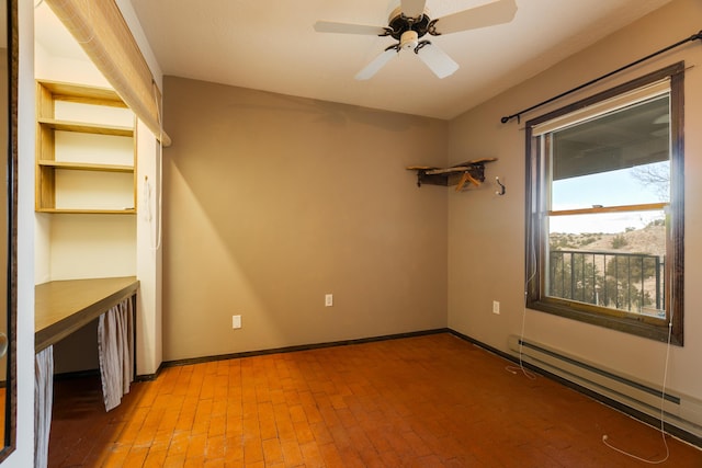 unfurnished room featuring ceiling fan and baseboard heating