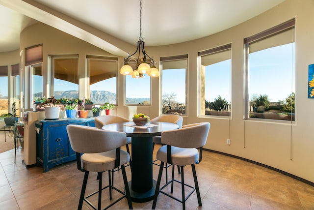 dining space featuring light tile patterned floors, a mountain view, and a notable chandelier