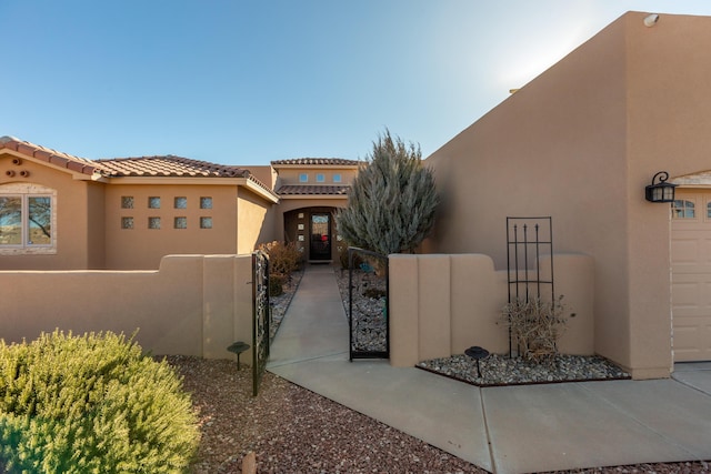 view of gate with a fenced front yard