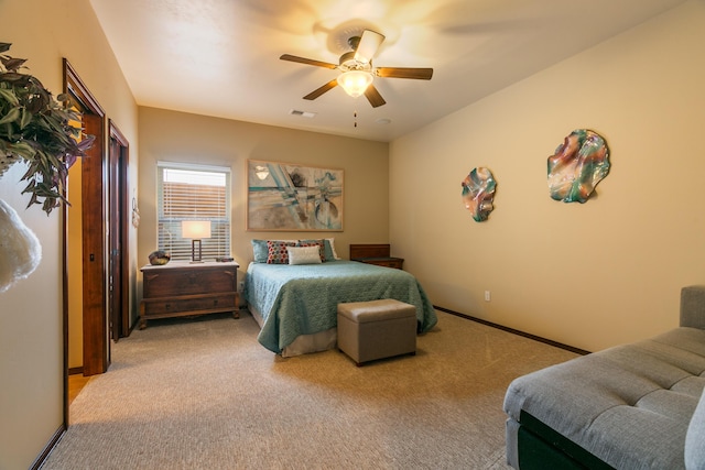 bedroom featuring baseboards, a ceiling fan, visible vents, and light colored carpet