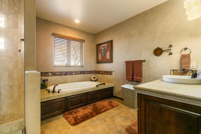 full bath with tile patterned flooring, tiled shower, vanity, and a bath