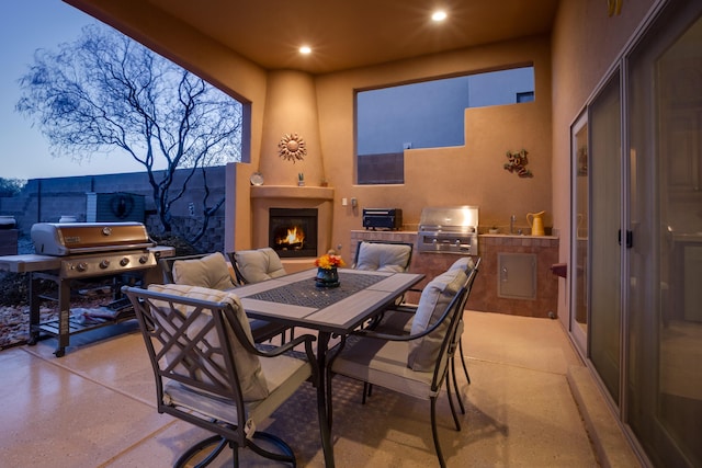 dining space with a large fireplace and recessed lighting