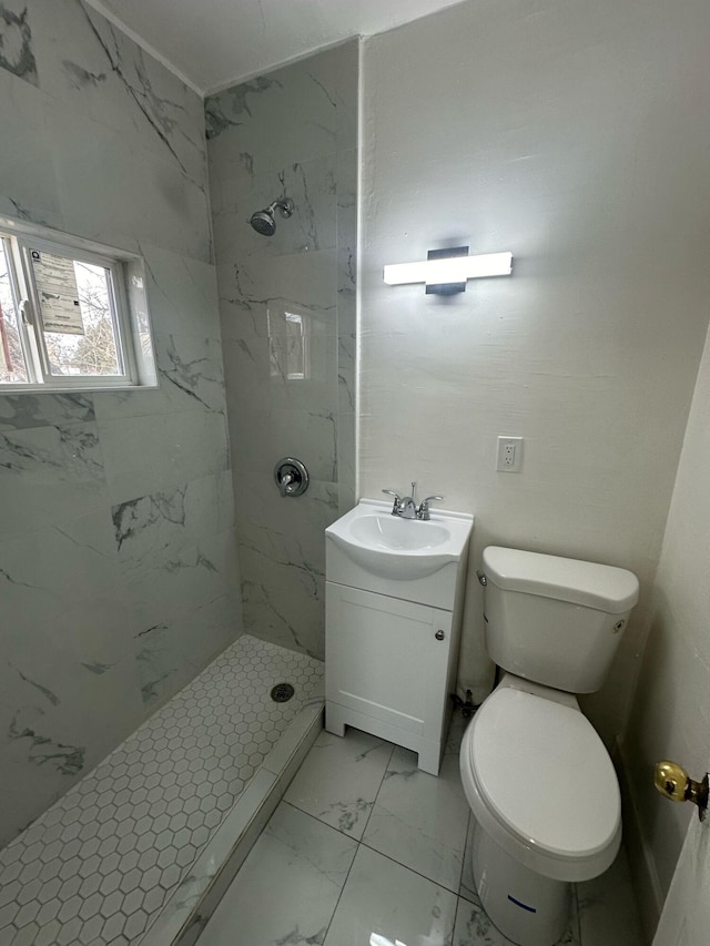 full bath with marble finish floor, vanity, a marble finish shower, and toilet