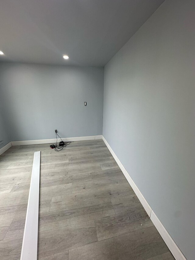 unfurnished room featuring recessed lighting, baseboards, and wood finished floors