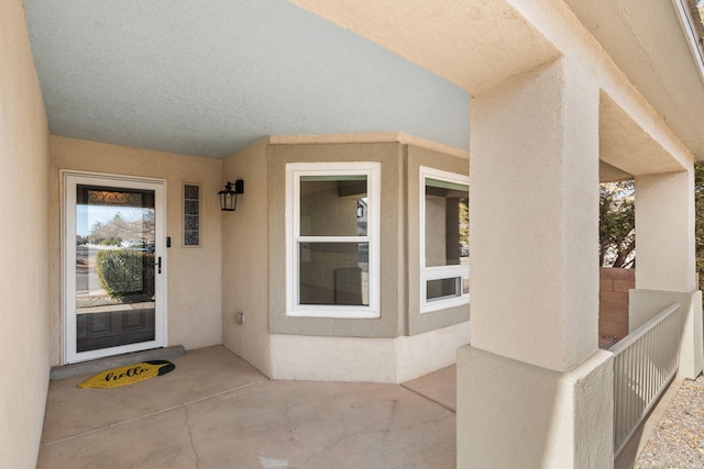 property entrance with stucco siding