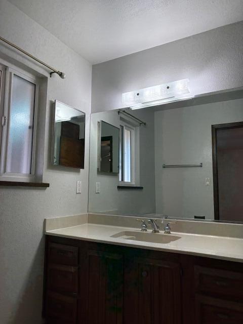 bathroom with vanity and a textured ceiling