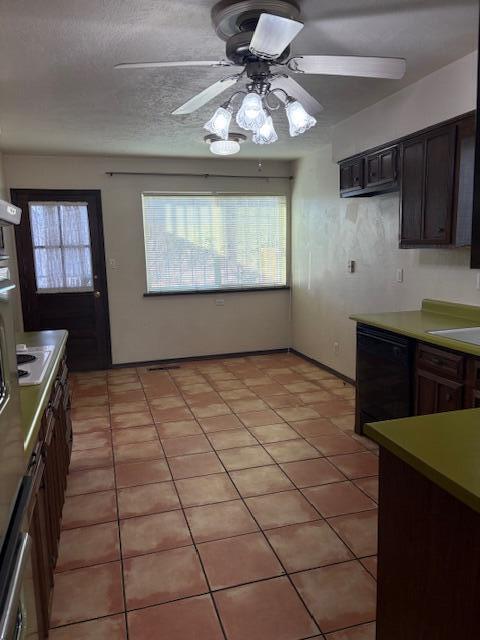 kitchen with light tile patterned flooring, black dishwasher, ceiling fan, dark brown cabinets, and a textured ceiling