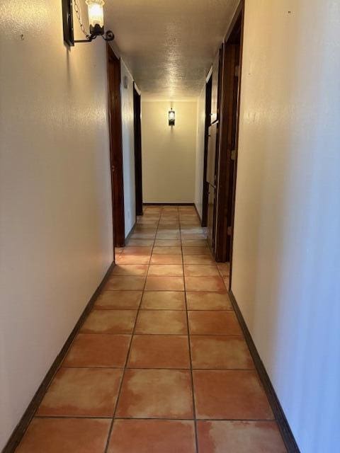 corridor featuring light tile patterned floors