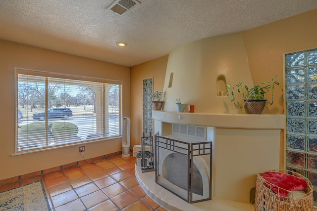 interior space with a textured ceiling and tile patterned floors