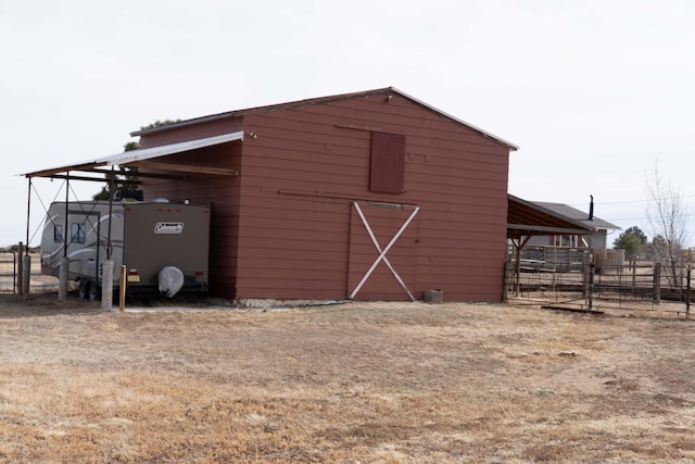 view of barn with fence