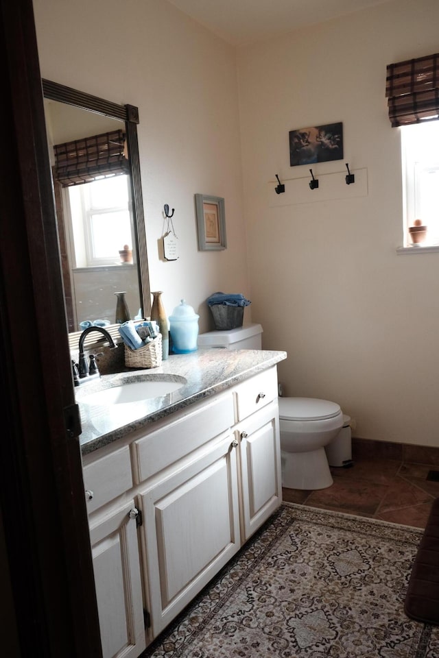 bathroom featuring vanity, toilet, and tile patterned floors