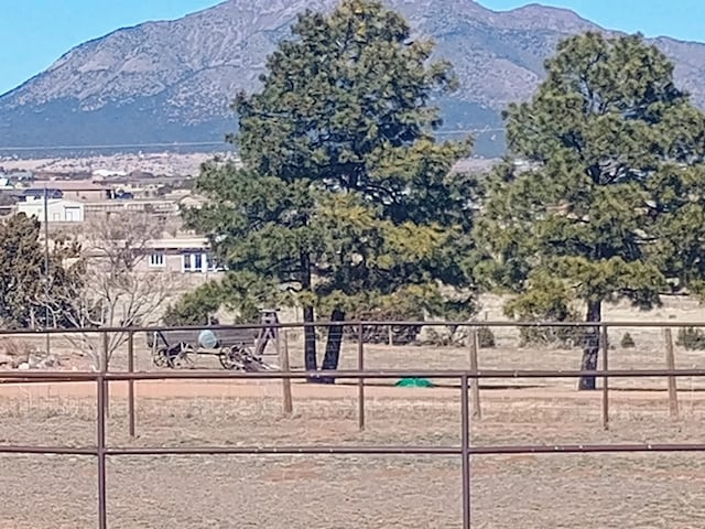 surrounding community featuring fence and a mountain view