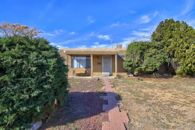 pueblo revival-style home featuring stucco siding